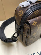 Louis Vuitton monogram crossbody bag close-up of side panel, textured leather trim