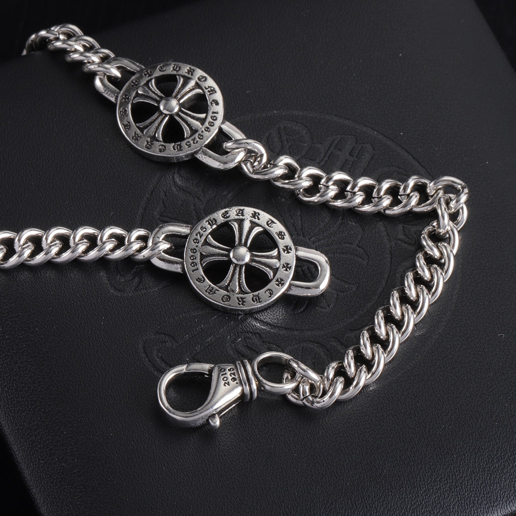 Silver-tone charm bracelet with round wheel charms and lobster clasp