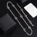 Silver-tone charm bracelet set with round wheel pendants and chain links