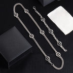 Silver-tone charm bracelet set with round wheel pendants and chain links