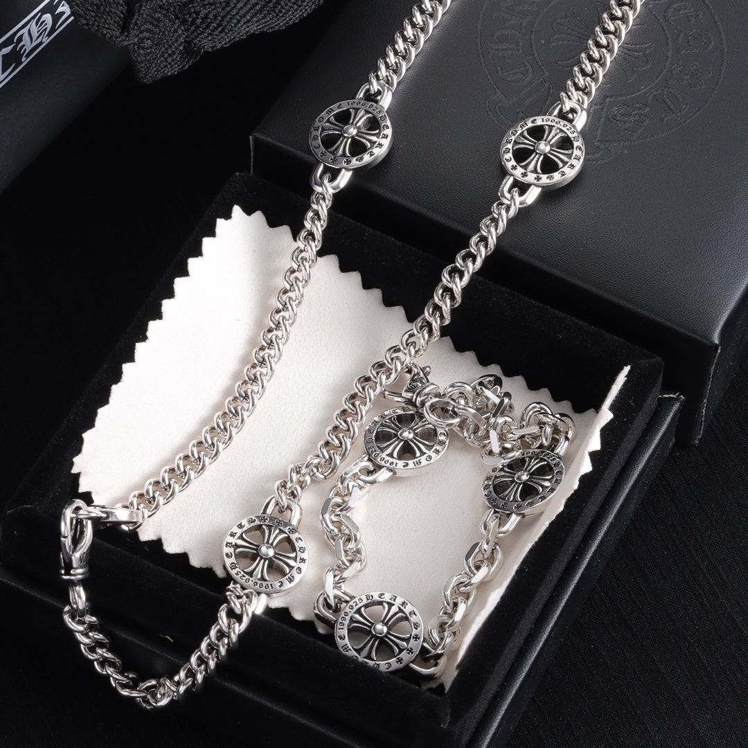 Silver-tone charm bracelet with round wheel charms and clasp, in gift box