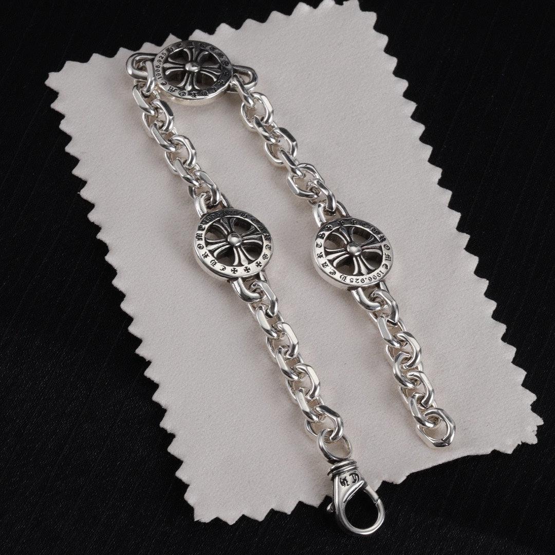 Silver-tone round wheel charm bracelets with chain links and clasp