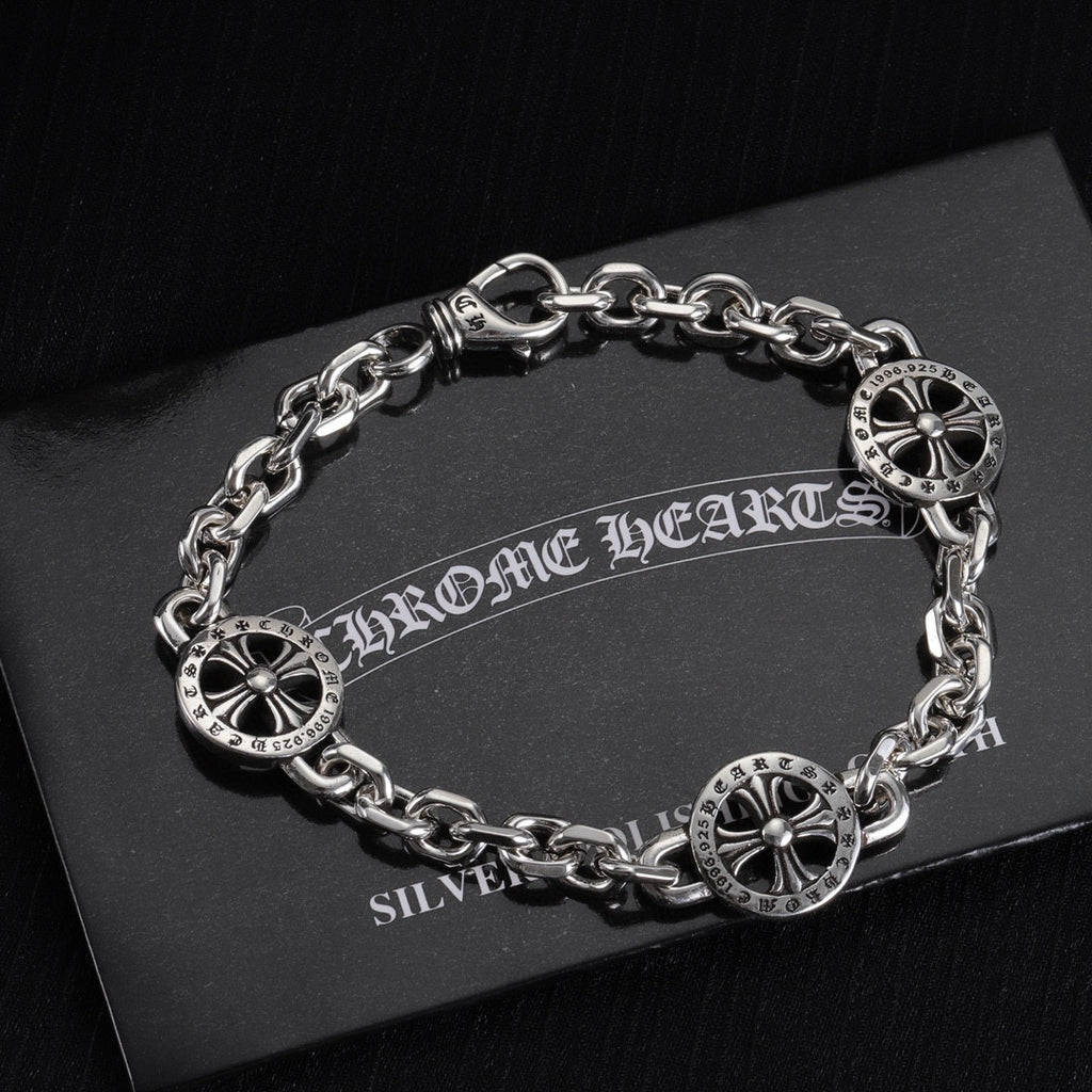 Silver-tone charm bracelet with round wheel charms and chain links