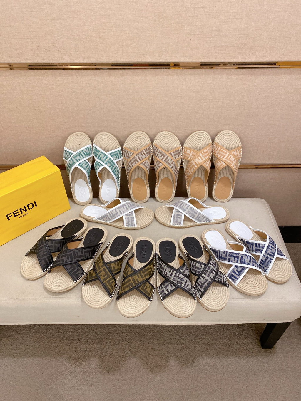 Assorted Fendi slide sandals on display, various monogram styles with woven soles