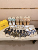 Assorted Fendi slide sandals on display, various monogram styles with woven soles