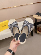Fendi monogram sandals pair view, black straps with cream woven soles