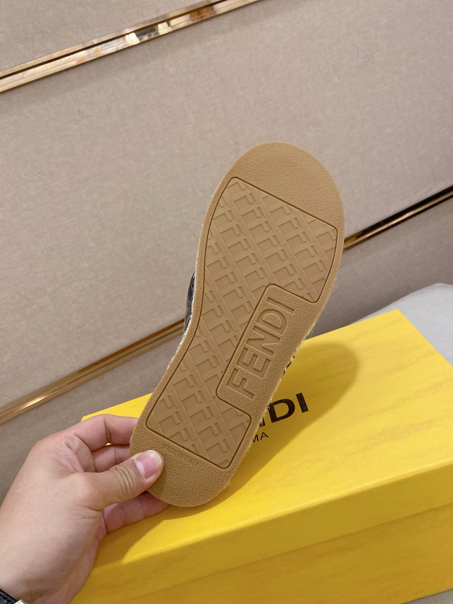 Fendi slide sandal outsole, textured tan rubber sole with Fendi branding.