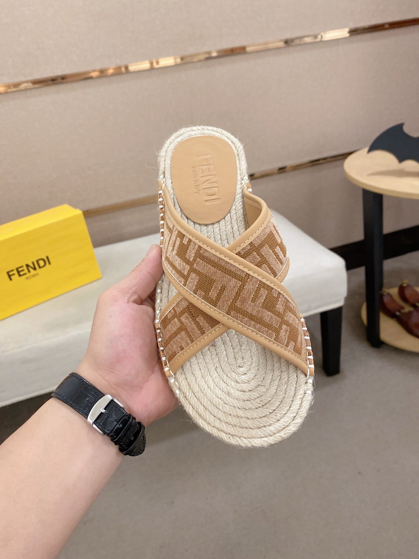 Fendi slide sandals, tan F-pattern upper with braided footbed and textured trim.