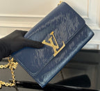 Louis Vuitton crossbody bag with gold LV emblem on navy blue flap