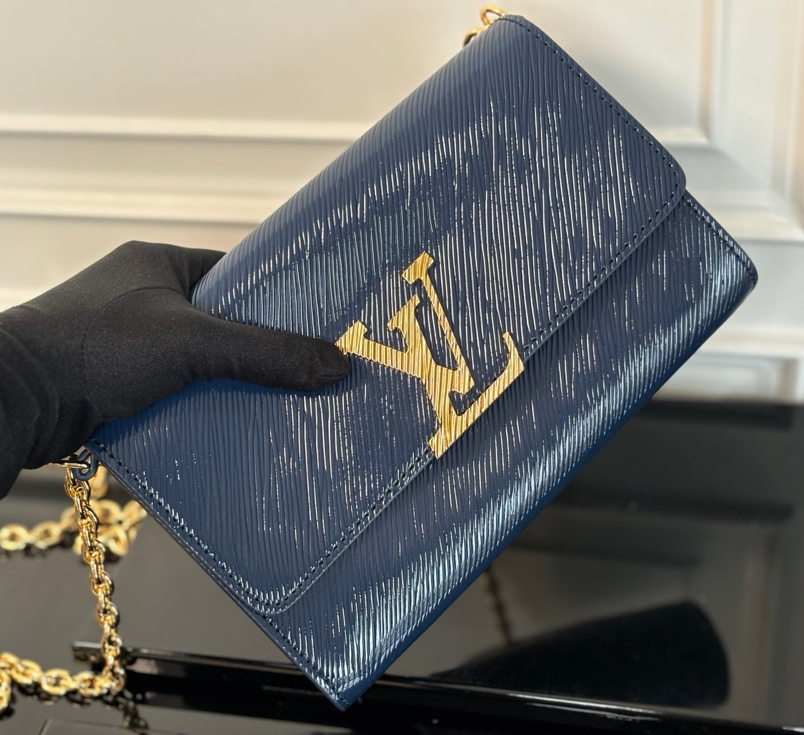 Louis Vuitton crossbody bag with gold LV emblem on navy blue flap