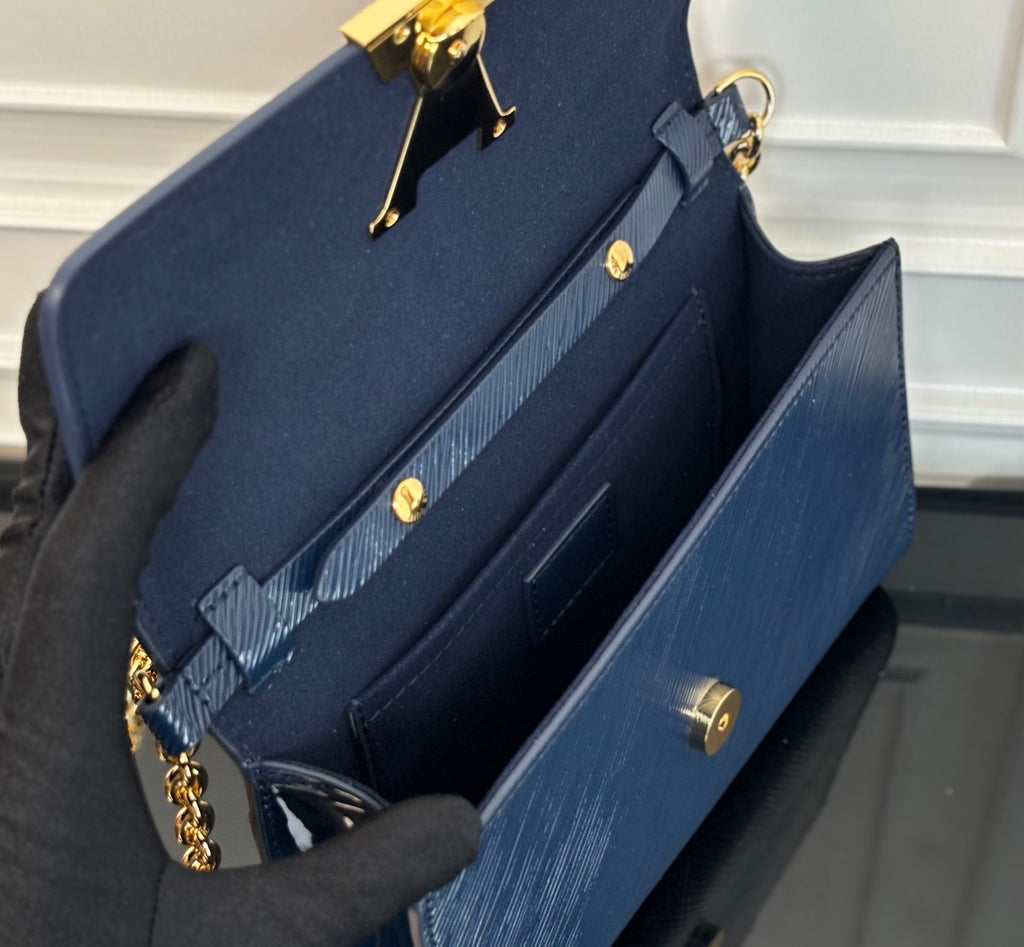Louis Vuitton bag with open interior view and gold turn-lock hardware