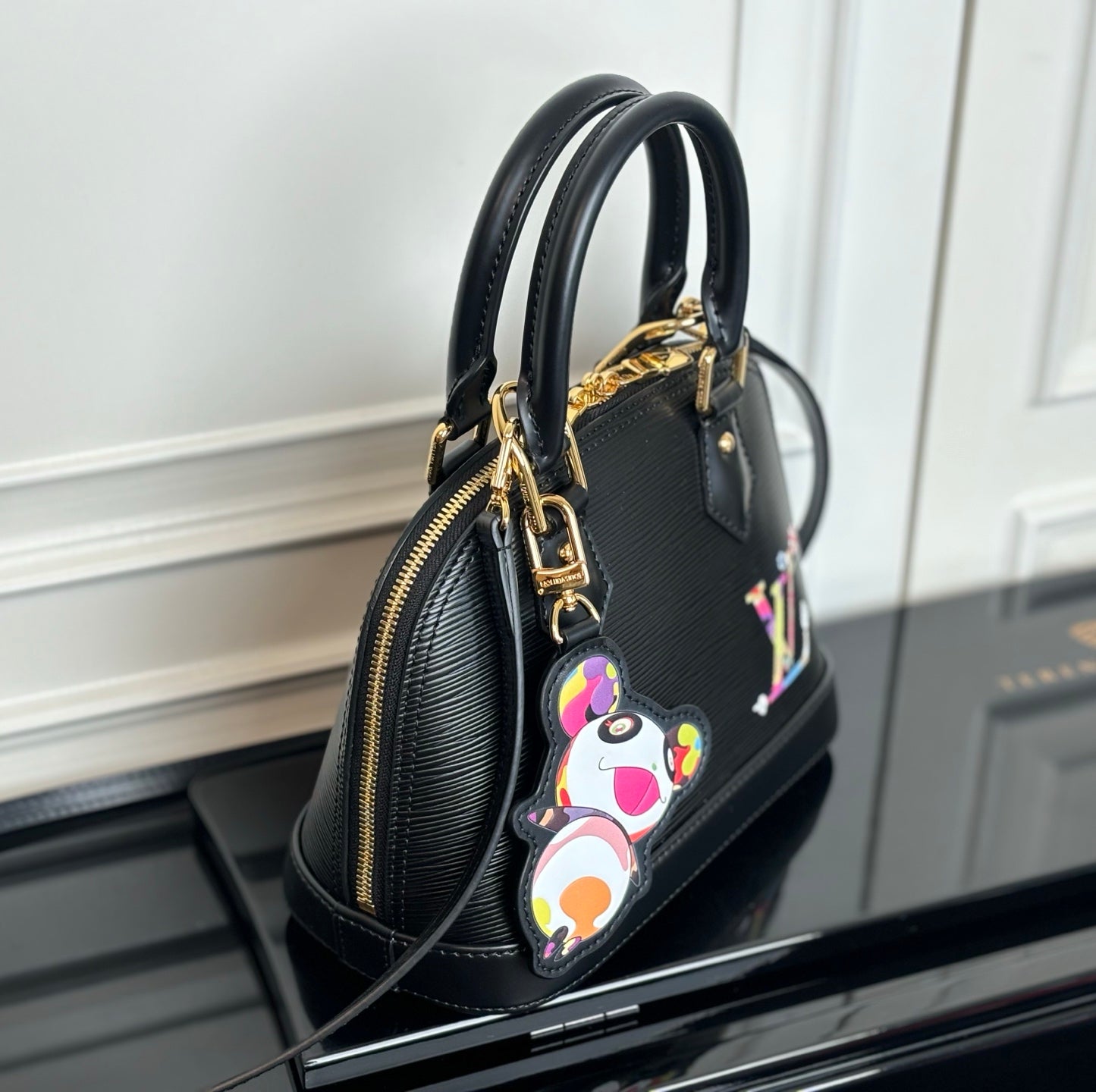 Louis Vuitton top-handle bag in dark with side zipper and multicolor dangling charm