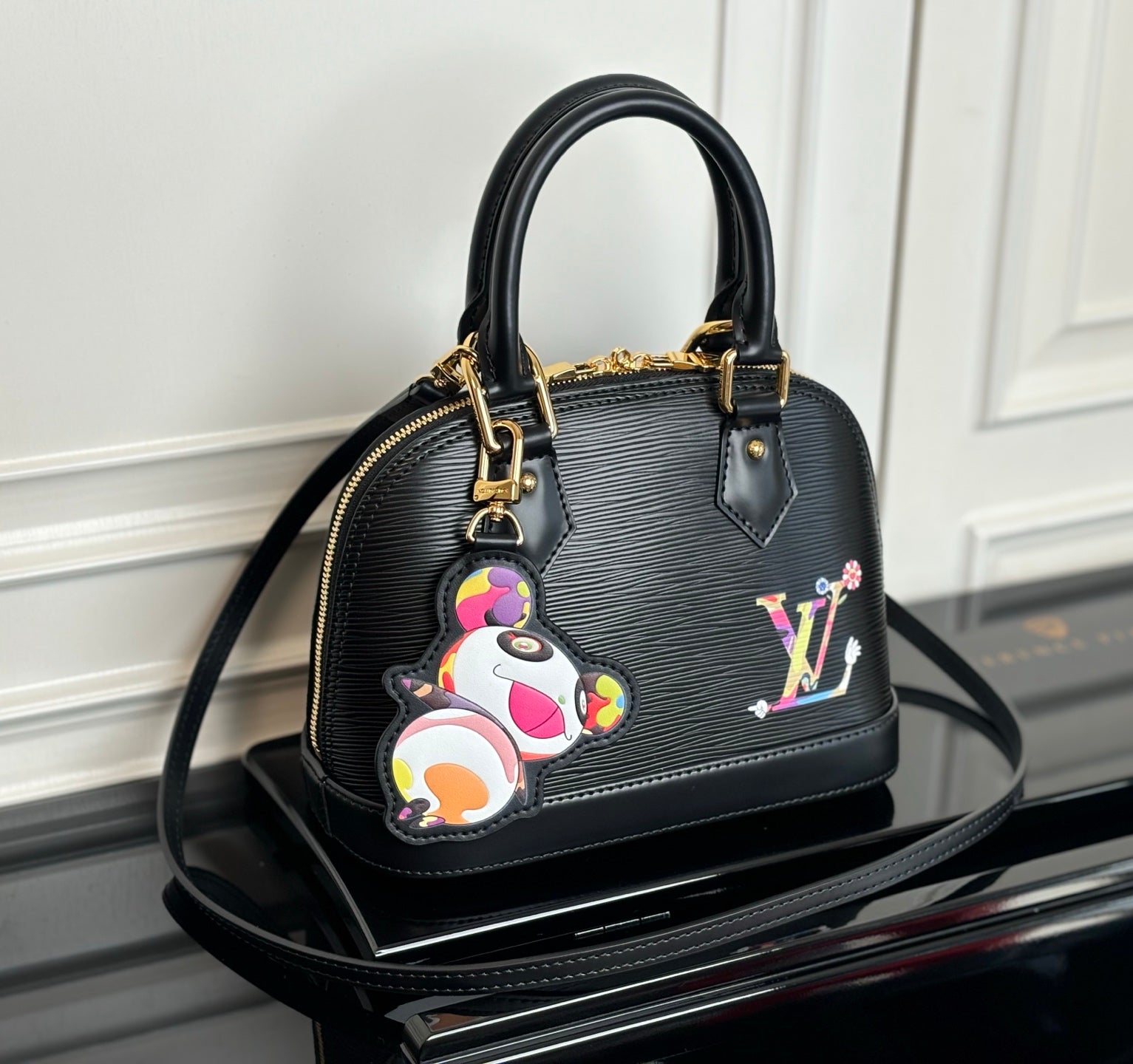 Louis Vuitton top-handle bag in dark with multicolor charm and gold hardware