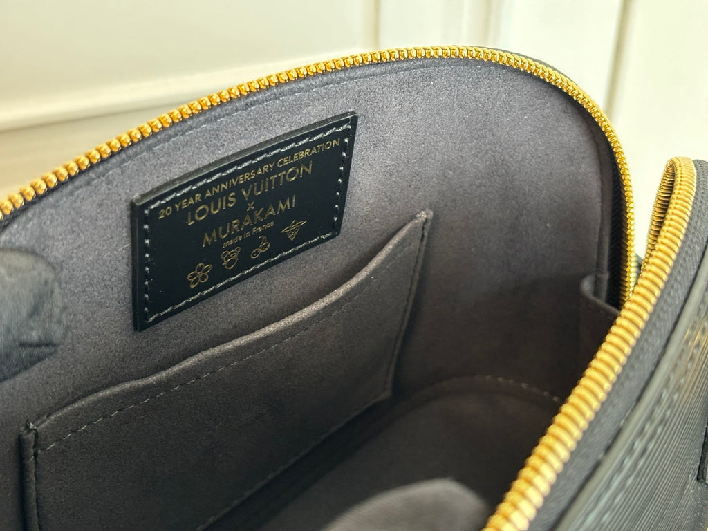 Louis Vuitton engraved interior label on black leather with gold zipper
