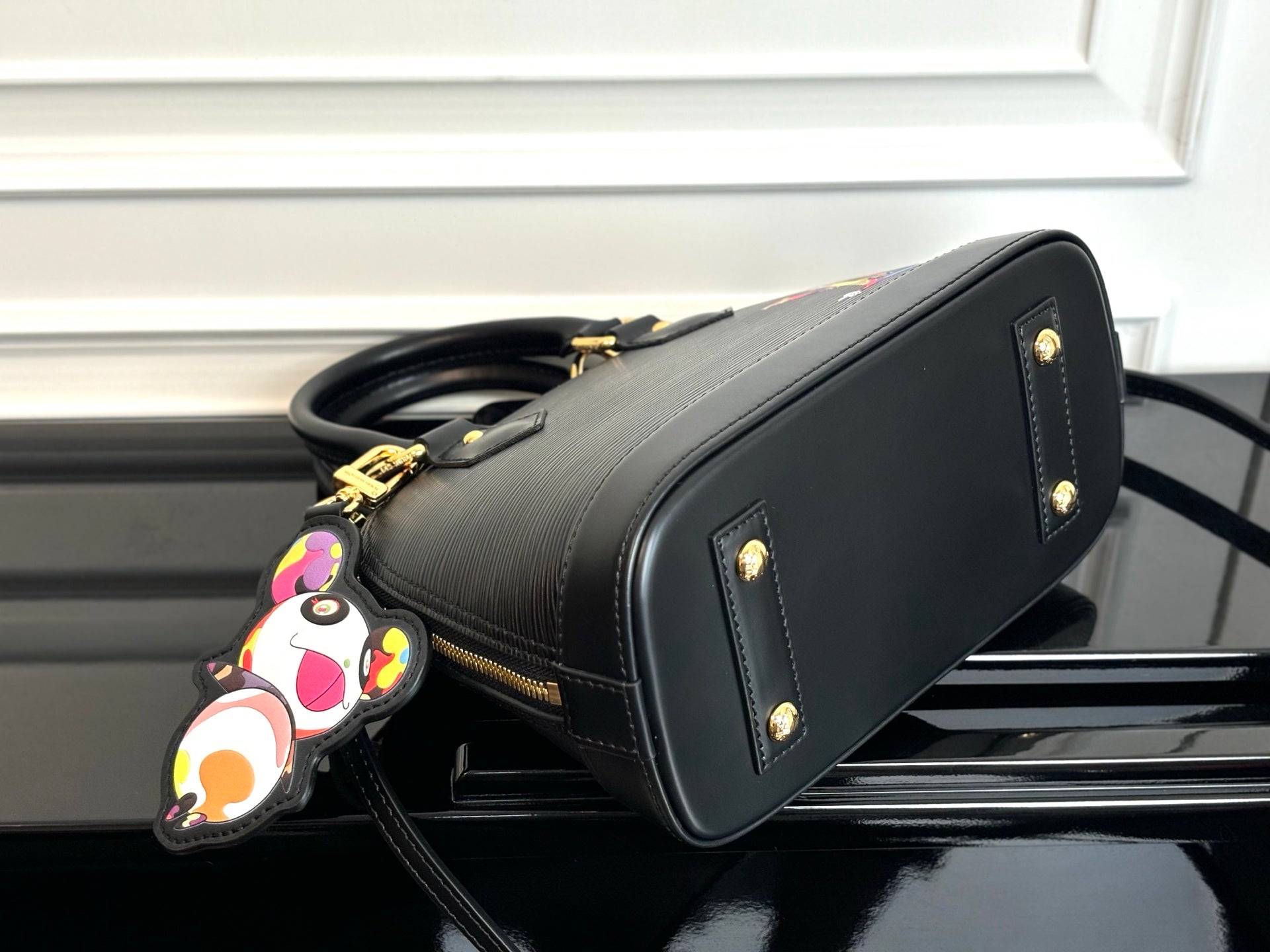 Louis Vuitton top-handle bag in dark with gold stud accents and stitched trim