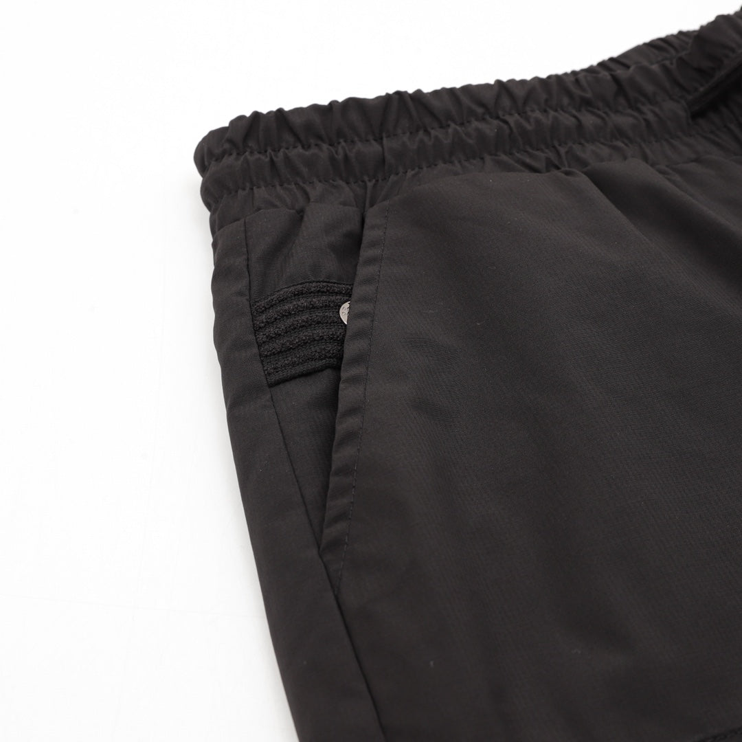 Black shorts close-up of elastic waistband and pocket seam