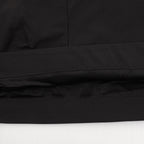 Black Prada shorts hem with stitched seam and perforated trim