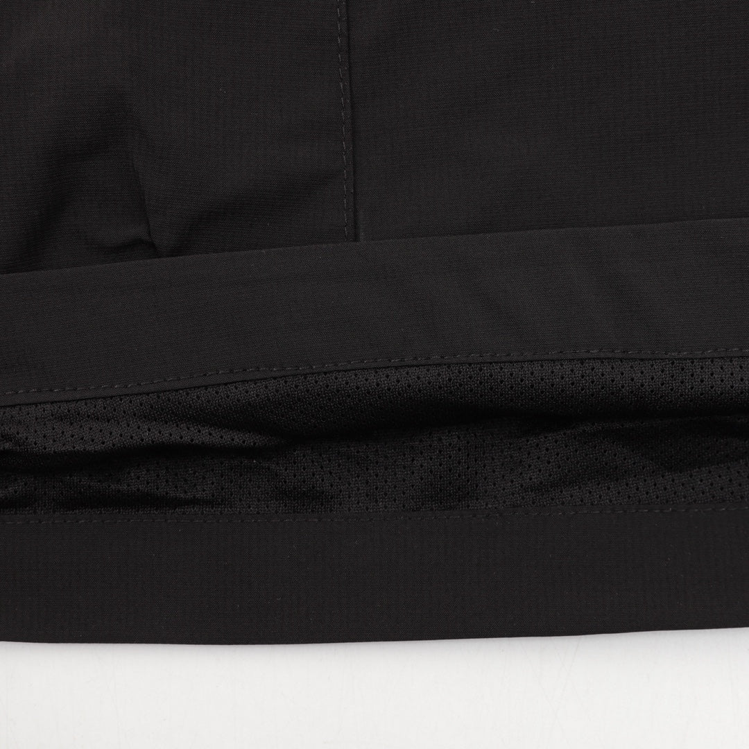 Black Prada shorts hem with stitched seam and perforated trim