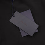 Black Prada shorts hang tag with gray labels on blue string