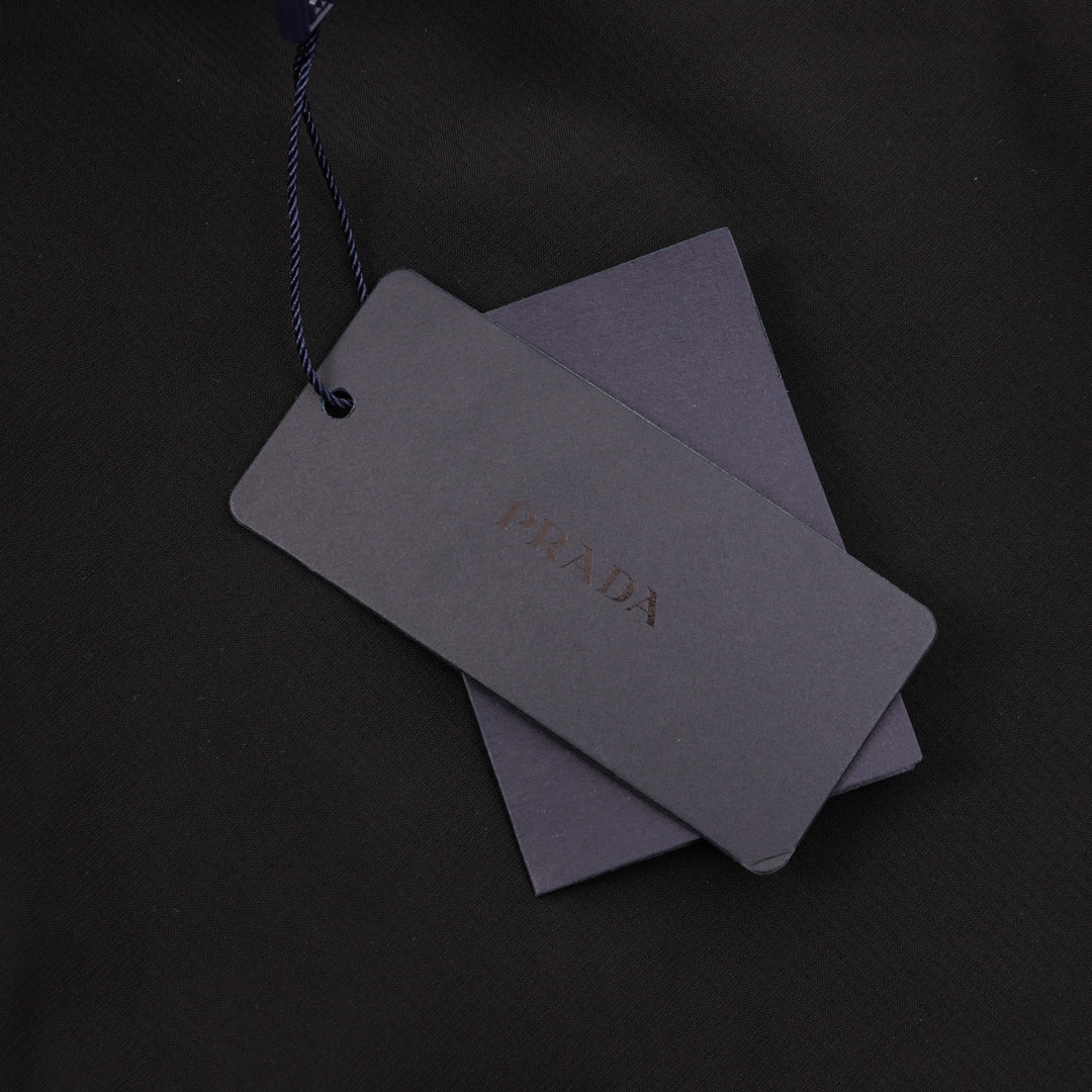 Black Prada shorts hang tag with gray labels on blue string