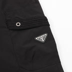Black shorts with eyelet patch pocket and Prada logo patch