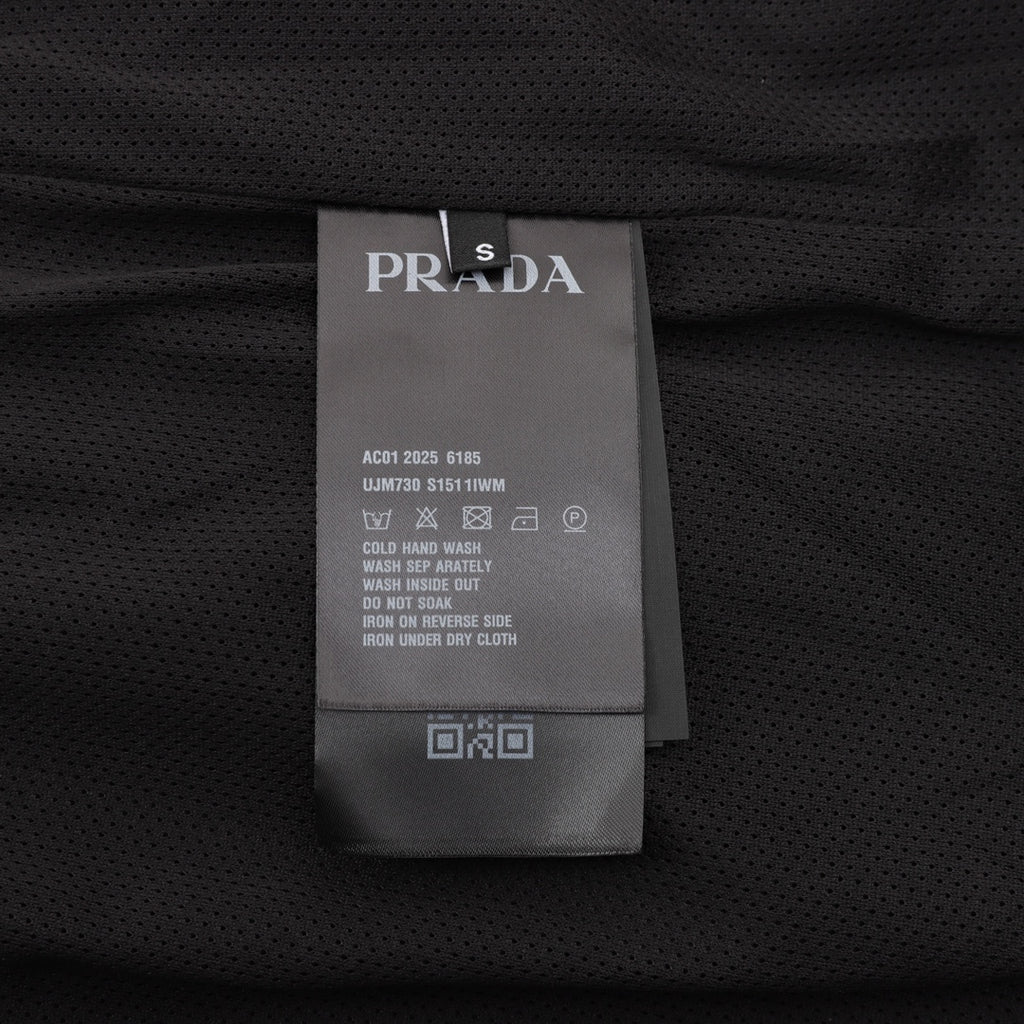 Prada care label on black shorts with size and wash instructions