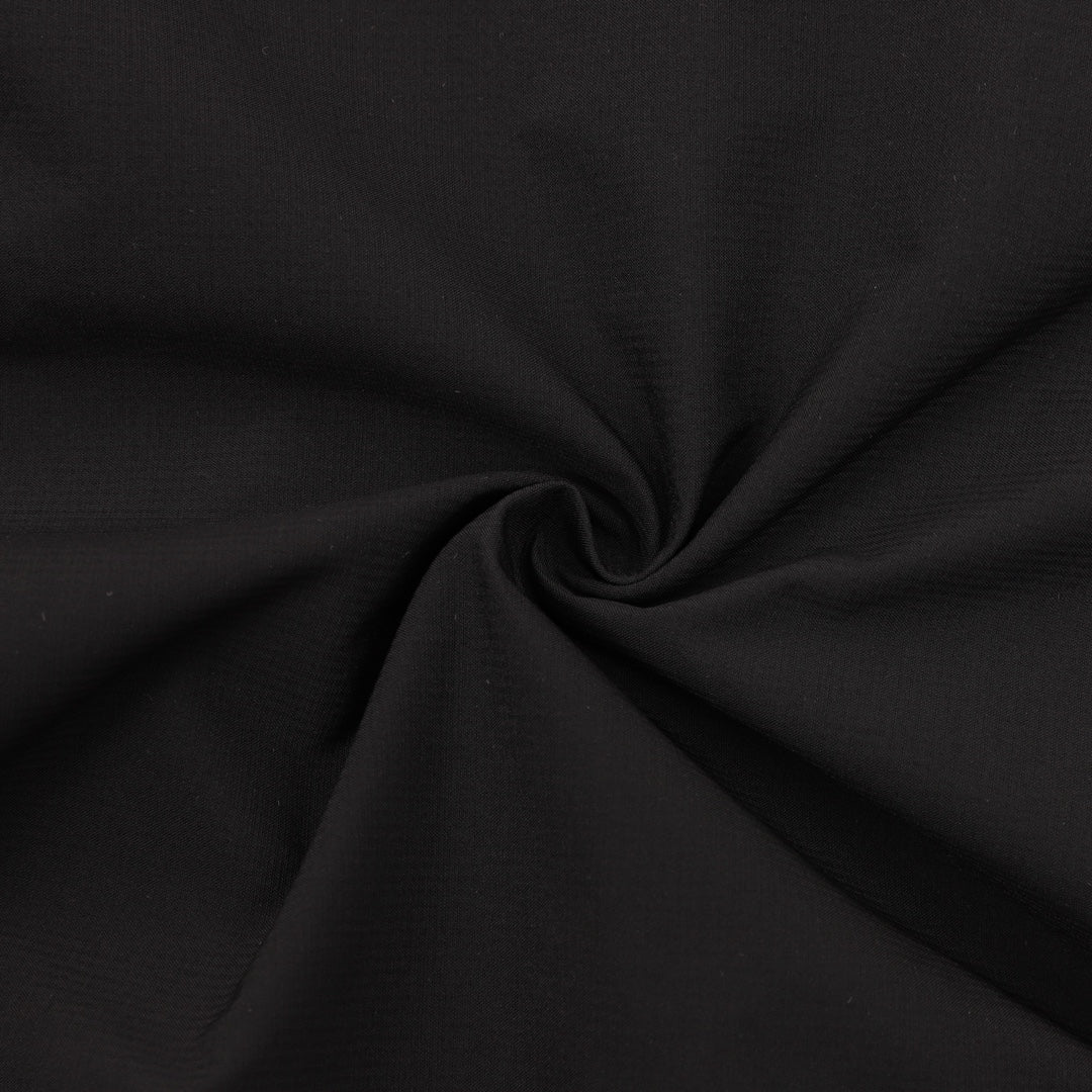 Black shorts fabric close-up with textured weave