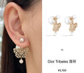 Dior gold dangling butterfly earrings with white pearl drop