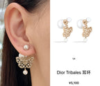 Dior gold dangling butterfly earrings with white pearl drop