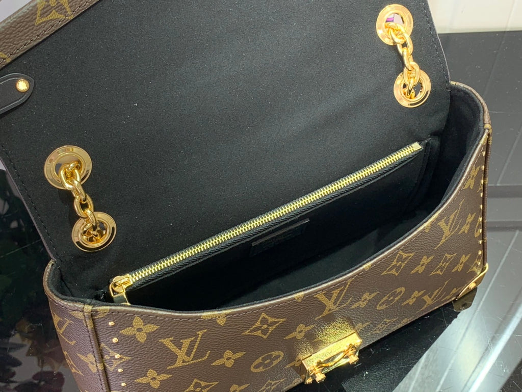 Louis Vuitton monogram bag open top showing black interior and gold zipper