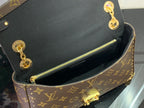 Louis Vuitton monogram bag open top showing black interior and gold zipper