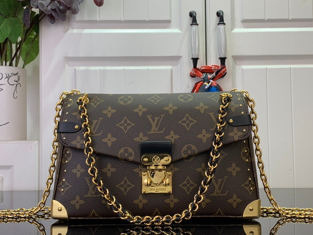 Louis Vuitton monogram bag with gold chain strap and front flap closure