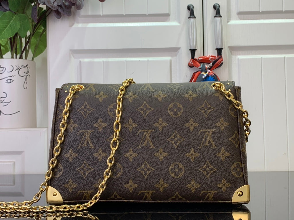 Louis Vuitton monogram bag front view with gold studs and chain strap
