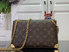 Louis Vuitton monogram bag front view with gold studs and chain strap