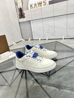White low-top sneakers with blue lining and layered blue lace detail