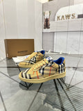 Check-pattern low-top sneakers with blue collar and lace-up front, tan rubber sole