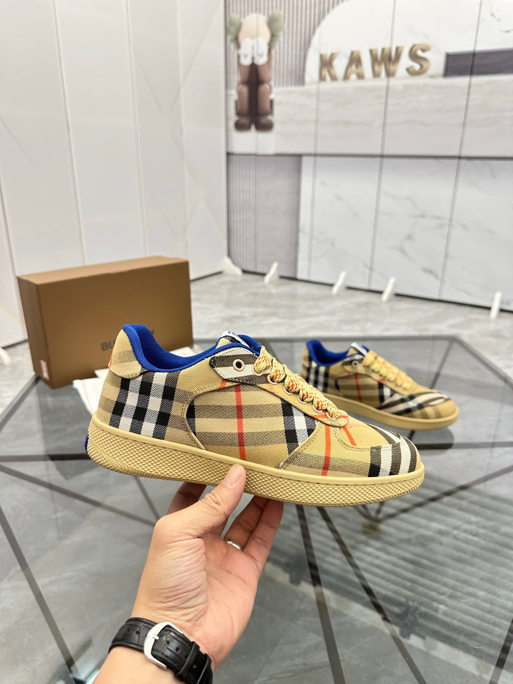 Handheld check low-top sneaker with blue trim, lace-up front, tan rubber sole