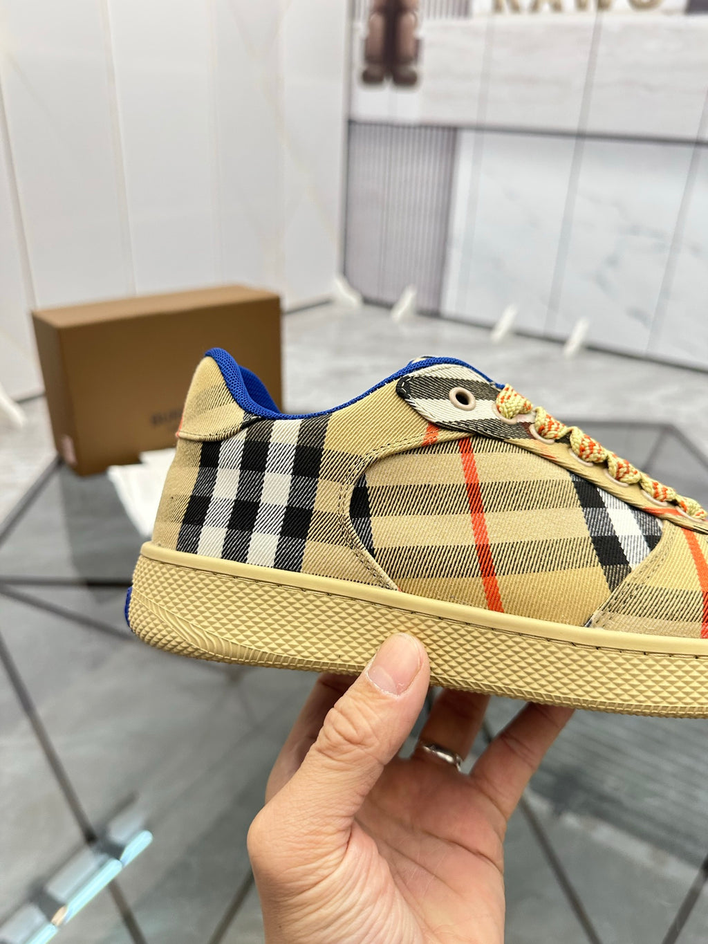 Side view check low-top sneaker with blue heel tab, lace-up front, tan sole