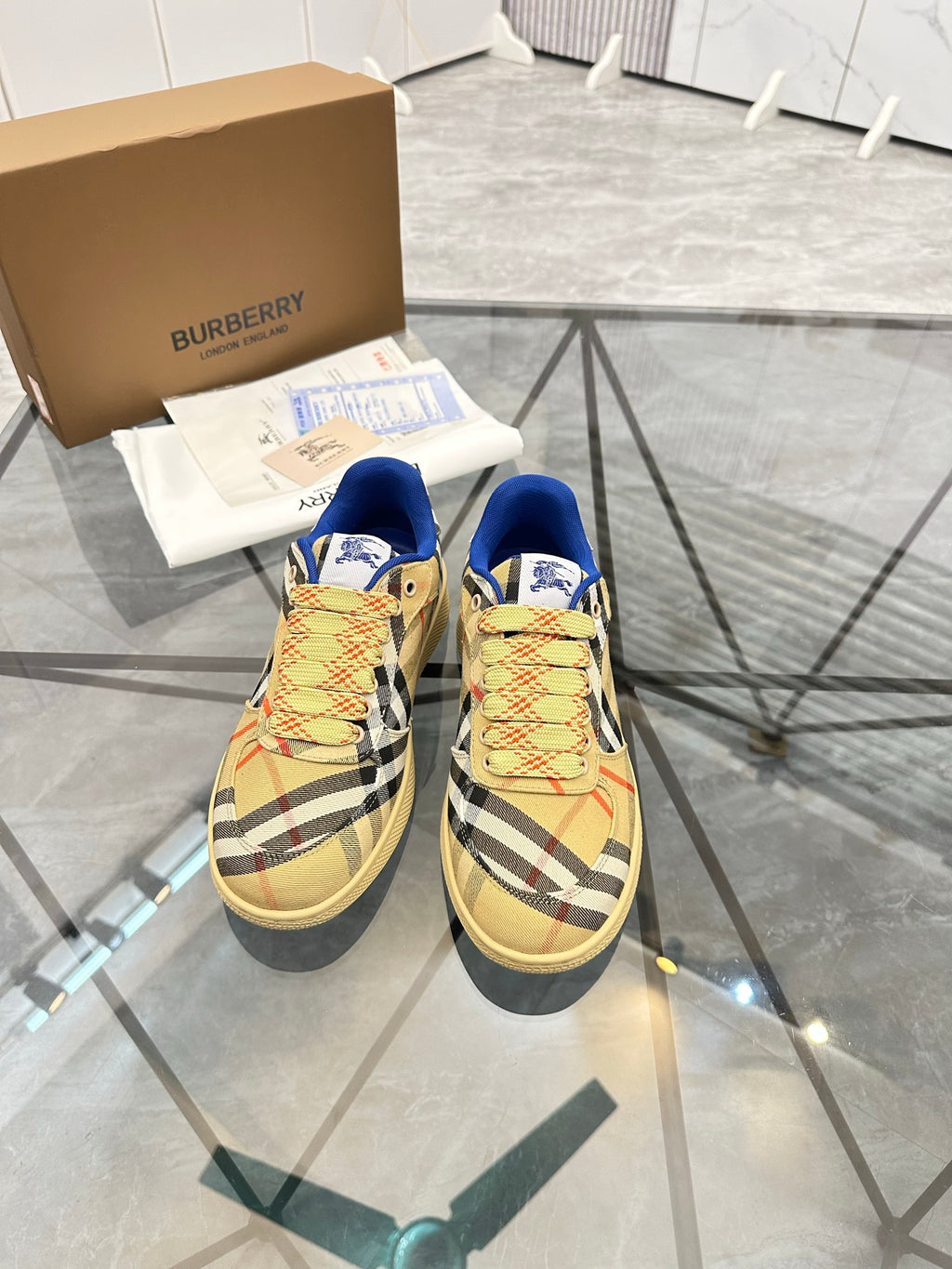 Pair of check low-top sneakers with blue lining, lace-up front, textured tan sole