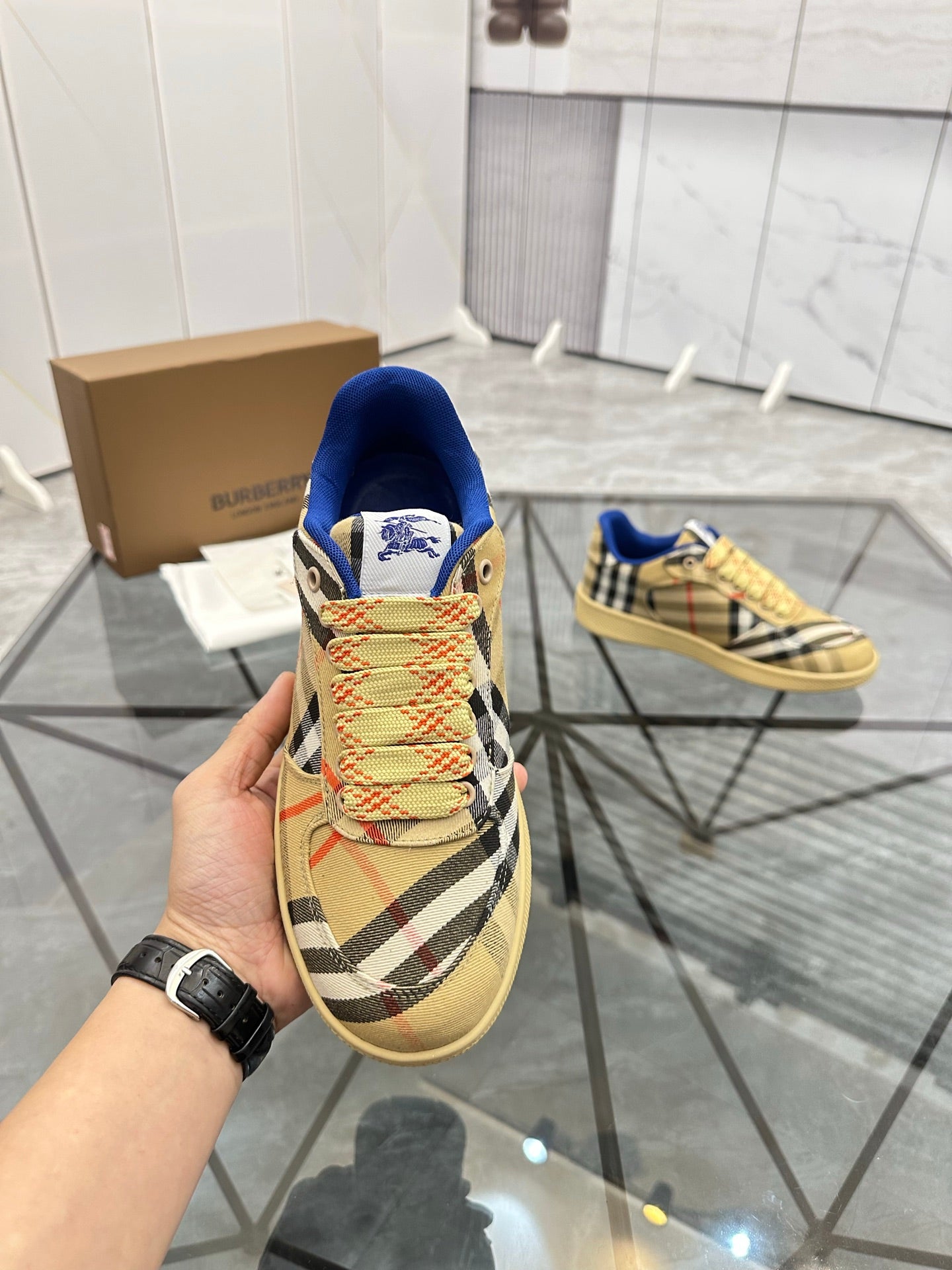 Check low-top sneaker close-up: blue interior, lace-up front, tan outsole