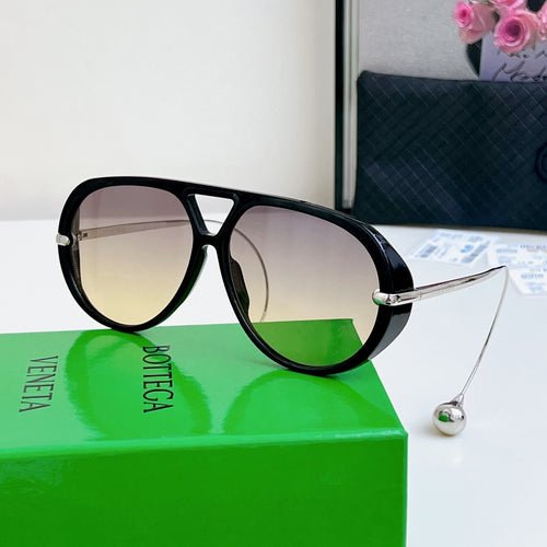 Sunglasses with black frame, silver arms, and light gradient lenses.