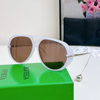 Sunglasses with white frame and brown tinted lenses; silver arms.