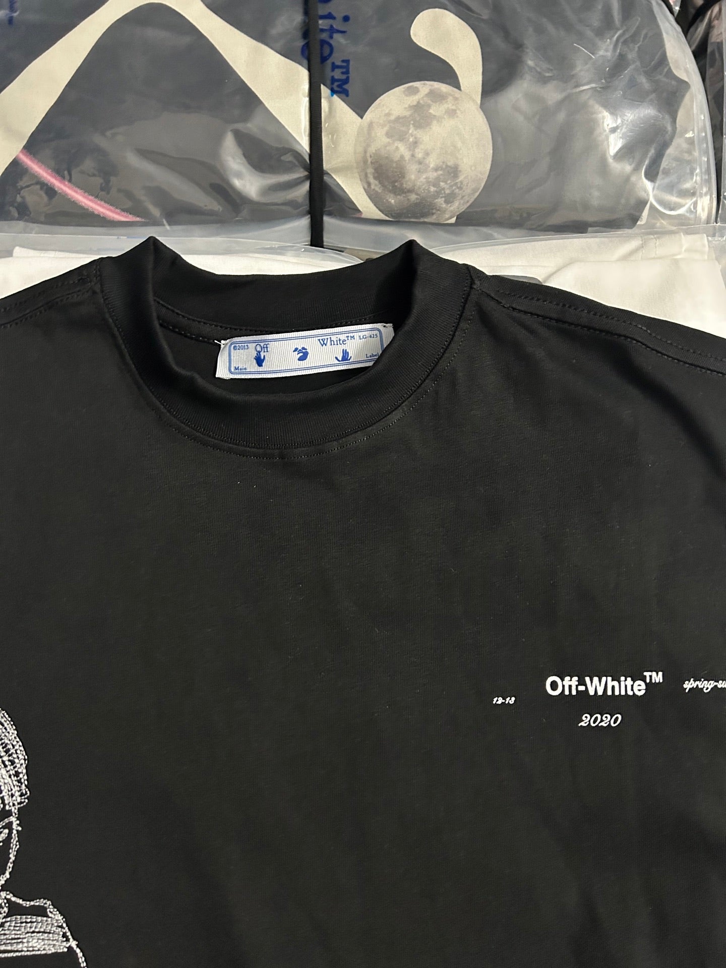 Off-White T-shirt close-up with white neck tag and small chest text