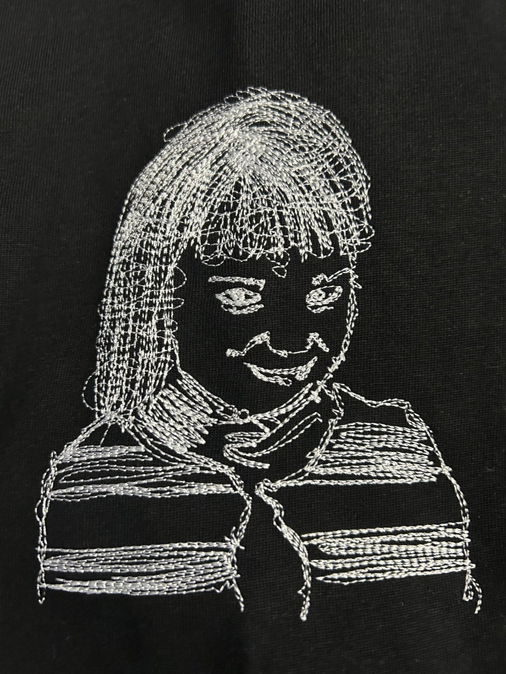 Off-White T-shirt close-up of white line-art face graphic