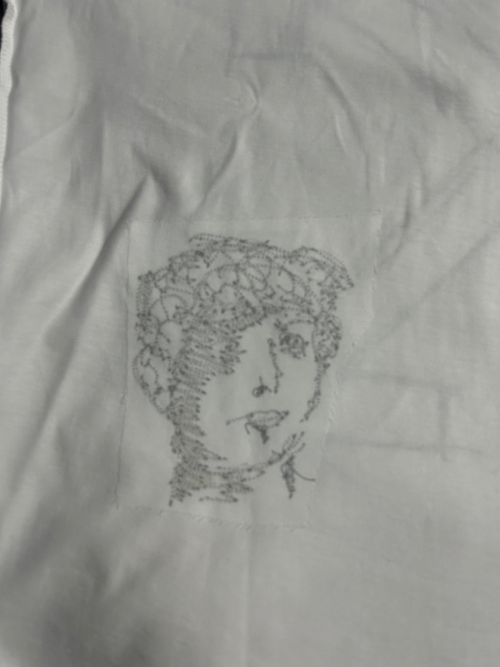 Off-White off-white T-shirt with small black line-art face portrait graphic