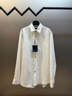 Long-sleeve button-up shirt in cream with spread collar and front placket buttons