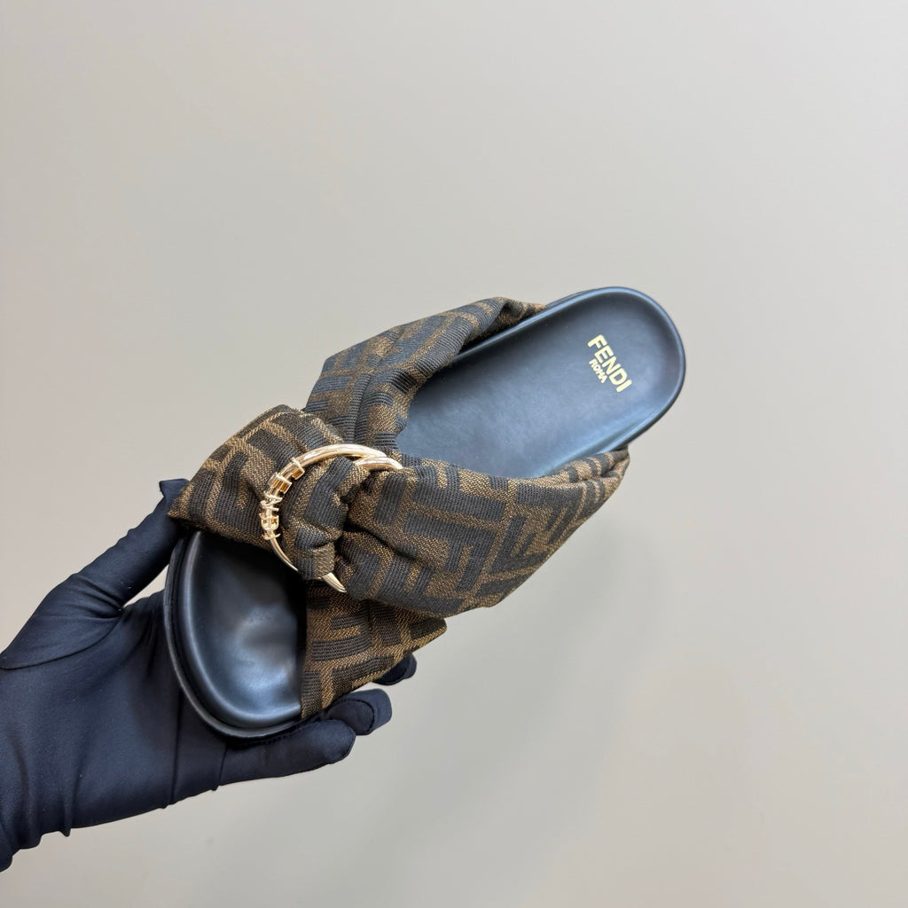 Fendi ladies slide sandal shown from side, FF-pattern fabric strap and buckle