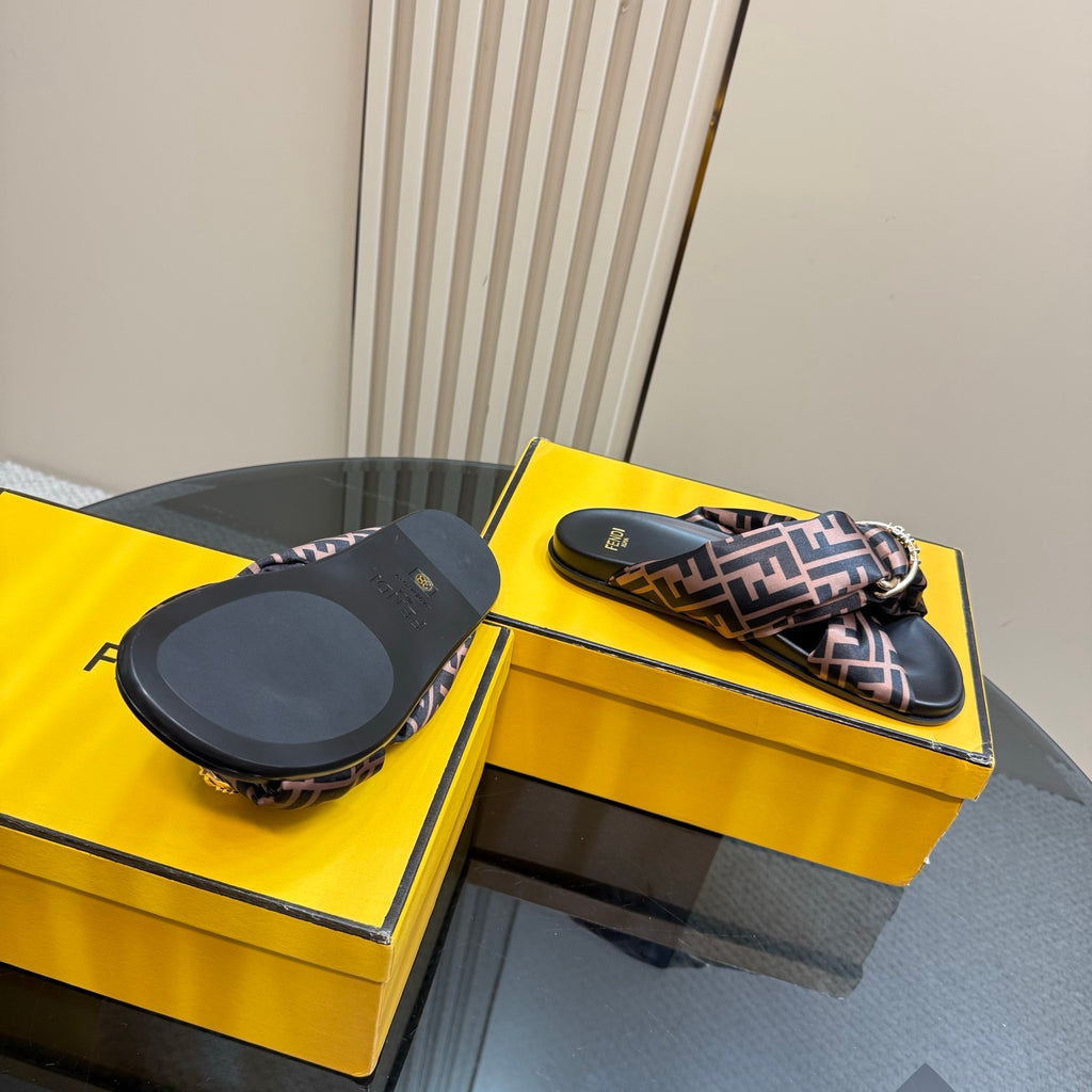 Fendi slide sandals showing outsoles on yellow boxes, FF logo straps