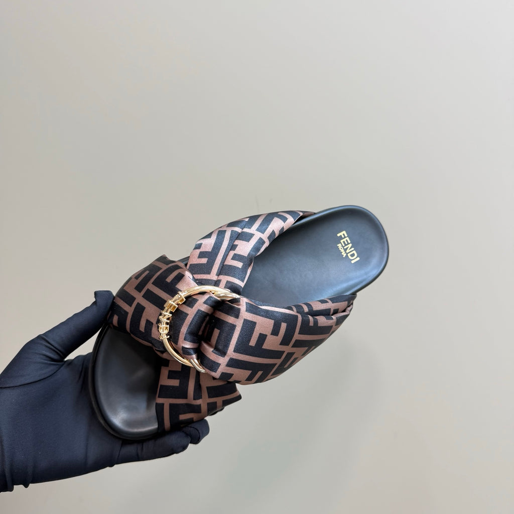Fendi slide sandal on hand, FF logo strap and dark molded footbed