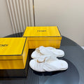 White Fendi slide sandals with gold chain and twisted strap detail